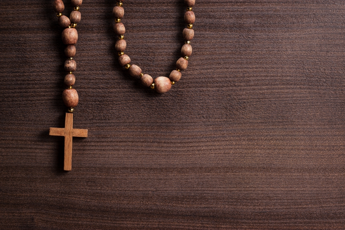 cross-over-brown-wooden-background-PPQBQPU-scaled.jpg