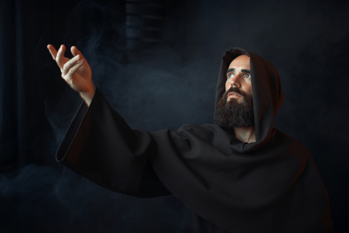 medieval-monk-praying-against-a-window-with-light-UTEYZGA-scaled.jpg